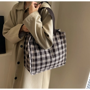 Detail of retro plaid tote bag showing textured tweed fabric and sturdy fabric shoulder straps