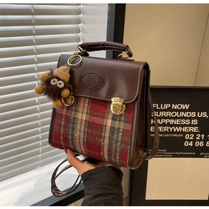 Detail of vintage plaid crossbody bag with brown PU leather and gold lock closure