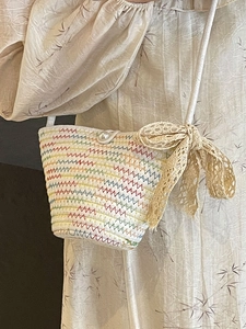 Handmade woven mini crossbody bag with colorful wave patterns and a pearl clasp