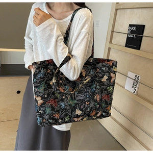 Macro detail of high-capacity canvas tote bag with vibrant butterfly jacquard patterns