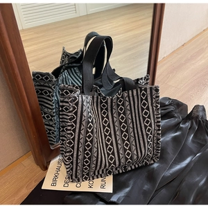 Detail view of ethnic tote bag with black and white geometric woven patterns and sturdy straps