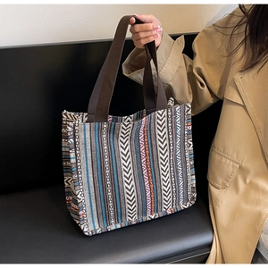 Close-up of ethnic striped fabric texture and durable woven handle on this tote bag