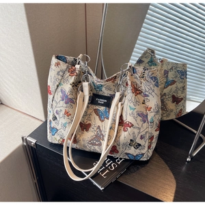 Detail of colorful butterfly jacquard tote bag with leather strap and silver metal rings