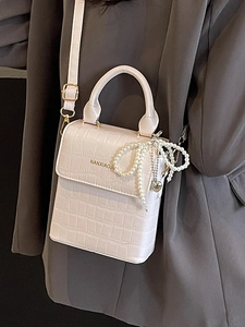Mini faux crocodile leather crossbody bag in light pink with pearl bow and heart charm