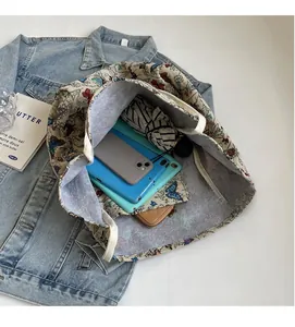 Top view of large canvas tote bag showing interior space with phone and umbrella