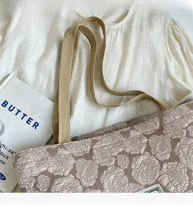 Detail of rose pattern texture and durable woven handle on vintage canvas tote bag