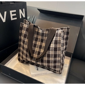 Detailed view of the vintage plaid tote bag inside an elegant gift box packaging
