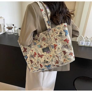 Detail of floral butterfly print on premium canvas tote bag with wide shoulder strap