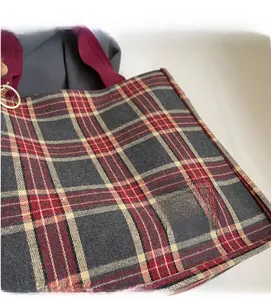 Close-up of vintage red and grey plaid canvas tote bag showing high-quality fabric texture