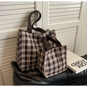 Detail of coffee and beige plaid tote bags in two sizes with textured woven fabric