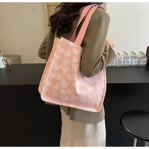 Pink jacquard tote bag with white hearts texture and reinforced woven shoulder strap