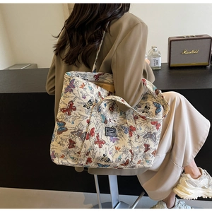 Detailed close-up of a butterfly pattern canvas tote bag in a vintage lifestyle setting