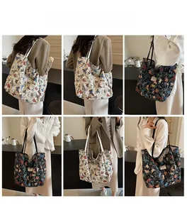 Detail view of large canvas tote bags with butterfly prints in beige and black colors