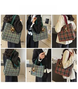 Detail view of large canvas tote bag with British plaid pattern and cute bear pendant