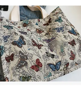 Detail of the butterfly jacquard texture on a large canvas tote bag for women