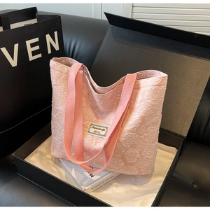 Pink jacquard tote bag with rose floral texture in premium black gift box packaging
