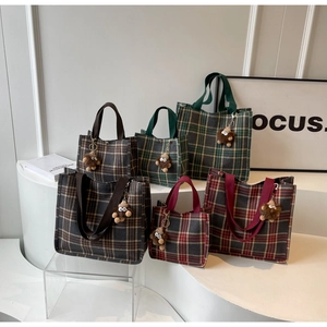 Detailed comparison of large and small retro plaid tote bags in brown, green, and red