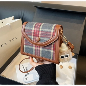Brown leather plaid crossbody bag with cute plush pendant and secure buckle closure