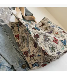 Detail of colorful butterfly embroidery and soft texture on a beige canvas tote bag
