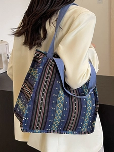 Ethnic style navy blue woven tote bag with colorful geometric patterns and wide strap