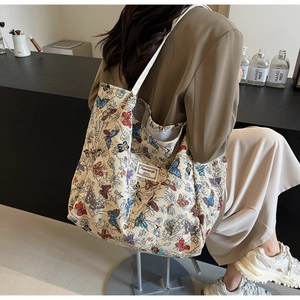 Detailed view of the large capacity woven tote bag with colorful butterfly embroidery patterns