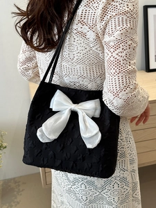 Chic Korean style black bucket bag with a large white bow and quilted texture