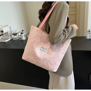 Detail view of pink 3D flower jacquard fabric on a stylish canvas tote bag