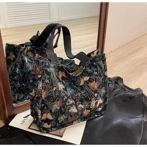 Close-up of vintage butterfly jacquard weave on large canvas tote bag with black strap