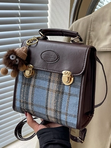 Vintage retro plaid backpack with blue tweed and brown leather featuring a cute monster charm