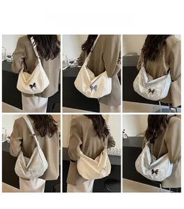 Vue arrière de mannequins portant des sacs hobo à nœud papillon en beige et argenté poli