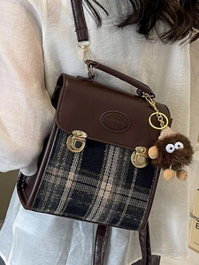 Retro plaid crossbody bag with dark brown leather trim and fuzzy monster charm