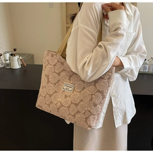 Close-up of light brown rose jacquard tote bag with stylish canvas shoulder strap