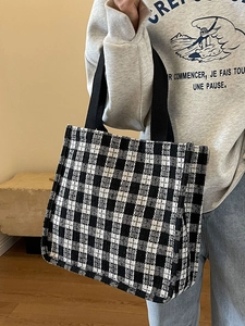 Fashionable black and white checkered tote bag with wide canvas straps for daily use