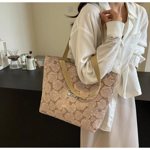 Detail of rose jacquard texture and strap handle on pink canvas tote bag for women