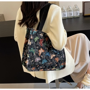 Detailed back view of a large tote bag featuring colorful butterfly jacquard patterns