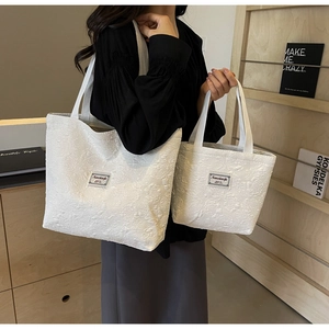 Detailed comparison of ivory floral jacquard tote bag and small handbag for women