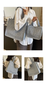 Detail of floral tote bag set with knit texture and wide shoulder strap in blue-grey