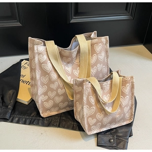 Close-up of heart-patterned tote bags set featuring premium jacquard fabric and canvas straps