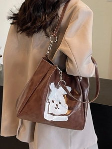 Brown leather tote bag with cute white cartoon rabbit print and slim shoulder straps