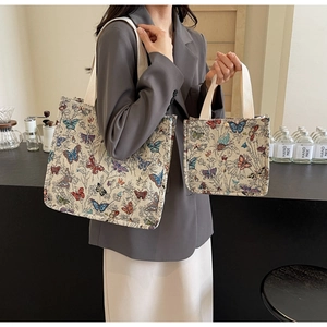 Detailed view of canvas tote set featuring colorful butterfly jacquard embroidery
