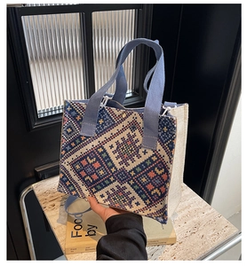 Detail of ethnic woven tote bag with geometric patterns and durable fabric handles