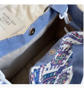 Detail of blue ethnic canvas bag showing silver magnetic closure and textured lining