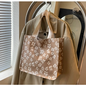 Detail of floral jacquard canvas tote with heavy fabric texture and wide straps
