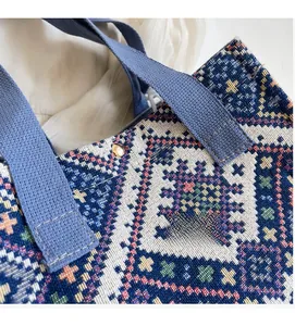 Detail of woven fabric texture and blue strap on ethnic style crossbody bag