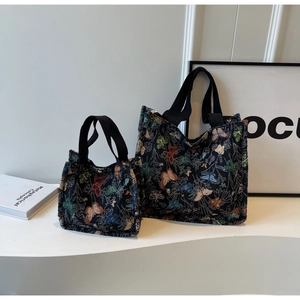 Detail of two jacquard tote bags with butterfly embroidery in large and small sizes