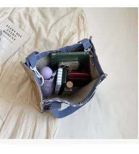 Interior view of spacious blue-white woven tote bag containing iPad, phone and accessories