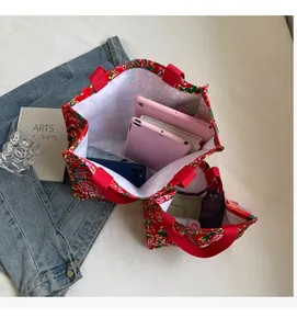 Macro view of floral tote bag interior showing capacity for tablets and essentials