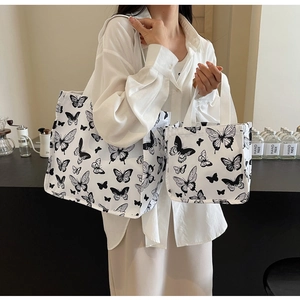 Detail view of canvas tote bag set with black butterfly print for daily commute