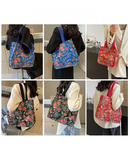 Detailed view of large capacity floral tote bags in blue, red and black canvas patterns