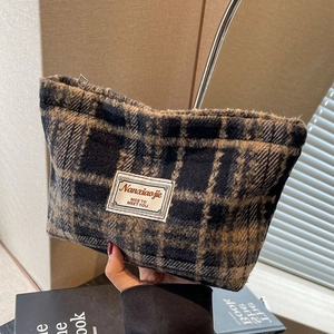Detail of checkered plush makeup bag with vintage pattern and soft fuzzy texture